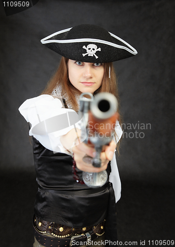 Image of Woman pirate aims in us from an ancient pistol