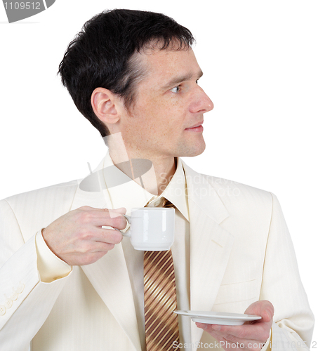 Image of Young man in business suit with cup of coffee