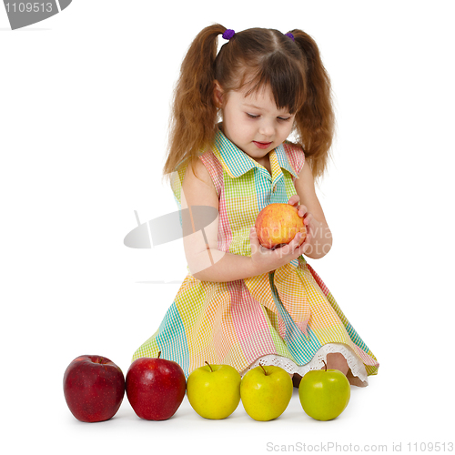 Image of Little girl on white background with apples