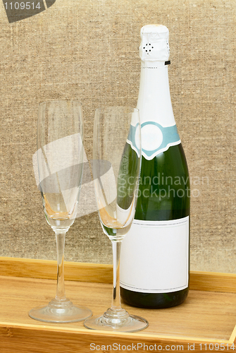 Image of Bottle of sparkling wine and two wine glasses