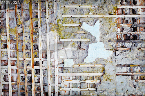 Image of Wooden planks in damaged old concrete wall