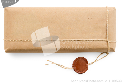 Image of Postal parcel in coarse paper on white background