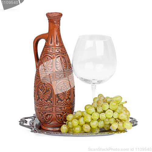 Image of Still life of ceramic bottle, grapes and glass