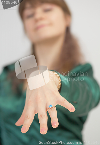 Image of Girl brags of new ring with blue stone