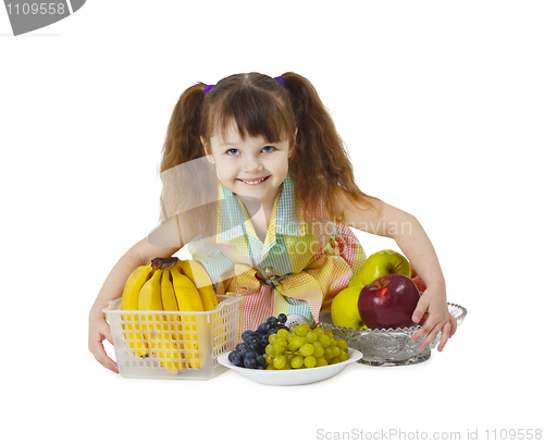 Image of Little girl with big bunch of fruit