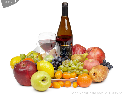 Image of Bottle of wine and glass surrounded by fruit