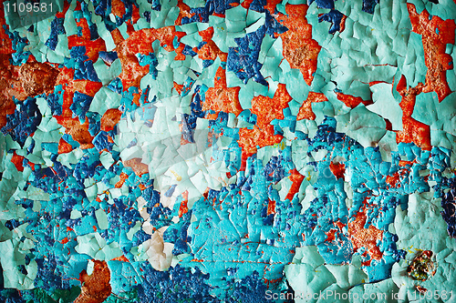 Image of Wall with colored flocks of old damaged paint