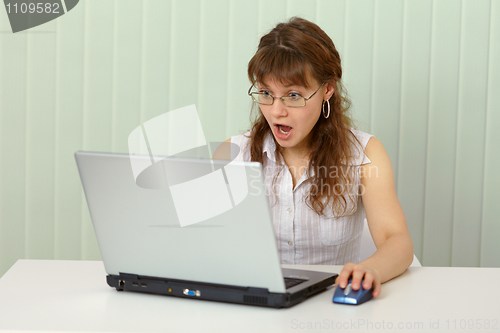 Image of Girl in indignation reads news on Internet