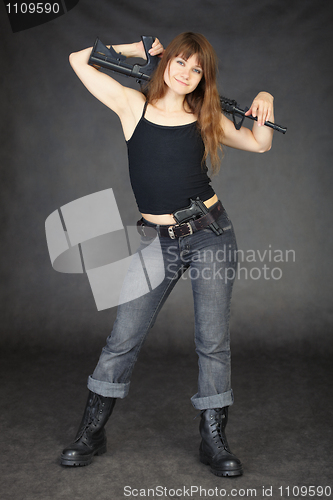 Image of Young woman with rifle on shoulders