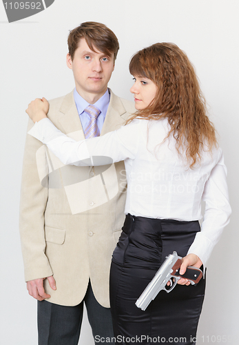 Image of Young man and beautiful woman with gun in hand