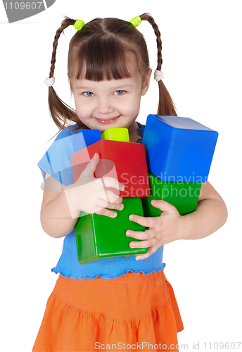 Image of Little happy girl with toys in hands