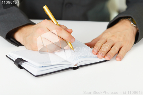 Image of Takes notes in organizer