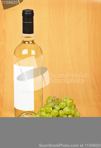 Image of Bottle of white wine and grapes