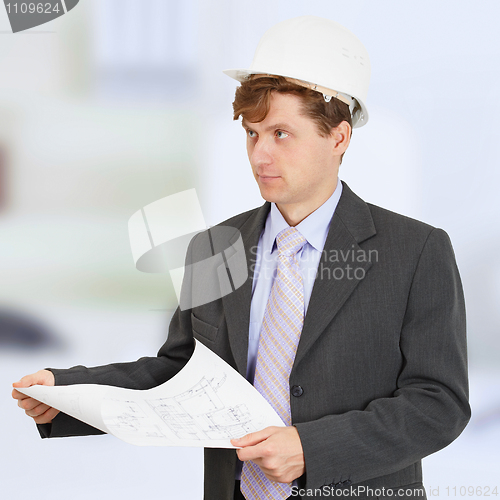 Image of Man in helmet with drawing in hands