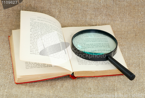 Image of Still life of magnifying glass and old book