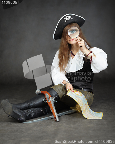 Image of Girl pirate, and map with a magnifying glass on black background