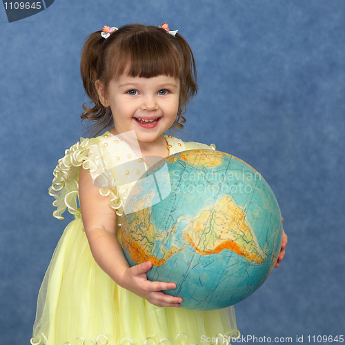 Image of Beautiful little girl with globe