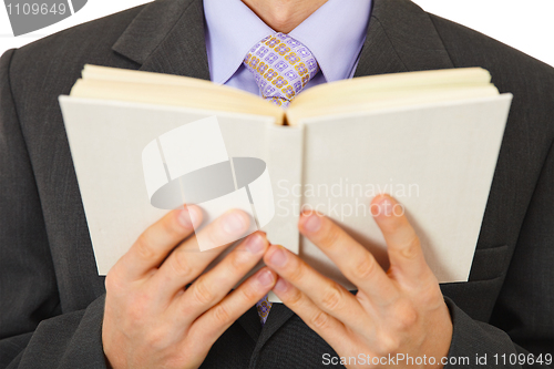 Image of Man in suit reads book