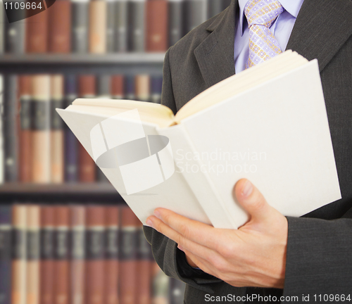 Image of Man reads a book in library