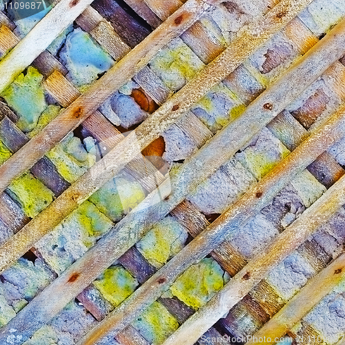 Image of Destroyed wall reinforced with wooden lattice