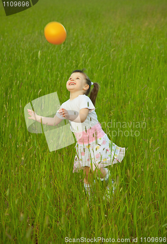 Image of Child cheerfully plays with ball