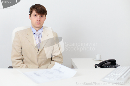 Image of Serious man in a business suit at work in office