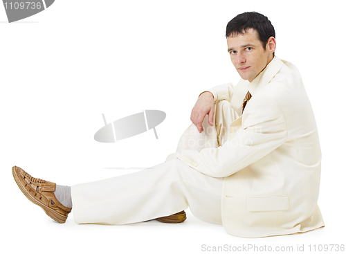 Image of Man in light business suit siting on white