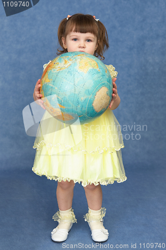 Image of Little girl holding a large globe