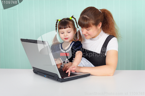 Image of Mom shows daughter work on computer