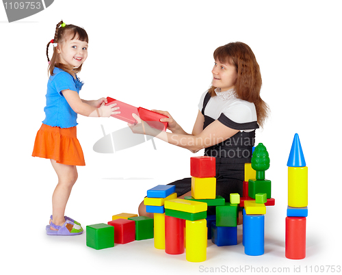 Image of Little girl with mother playing with colored blocks