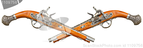 Image of Two crossed ancient pistols isolated on white