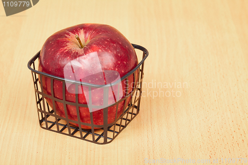 Image of Red apple in a small basket