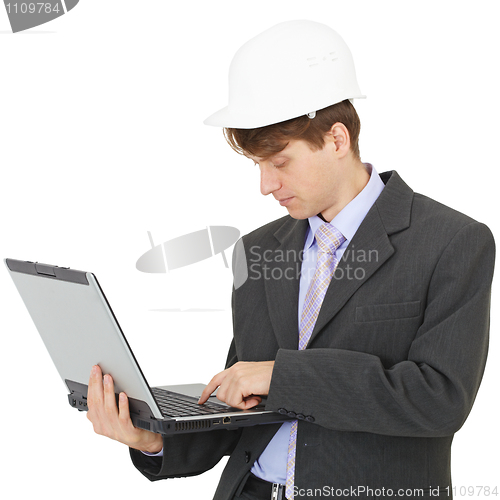Image of Builder works with laptop holding it on hands