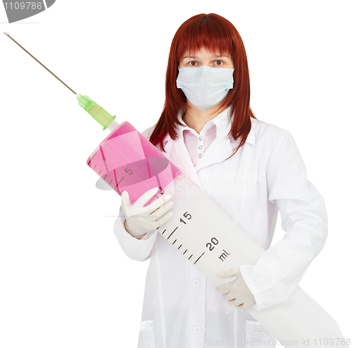 Image of Young woman doctor with big syringe in hands