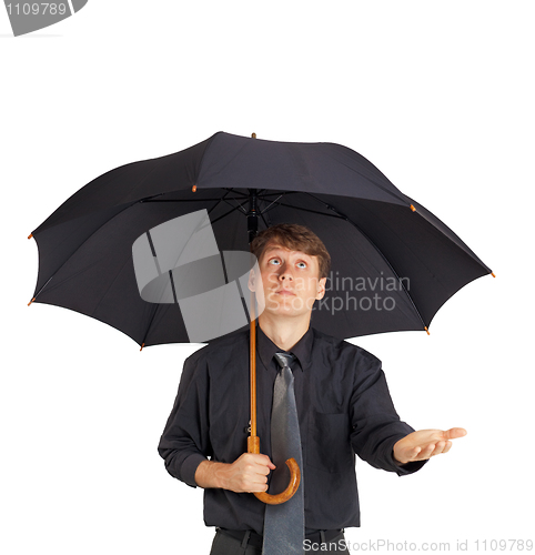 Image of Young man with large black umbrella