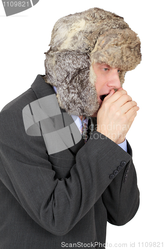 Image of Young man in fur cap freezes