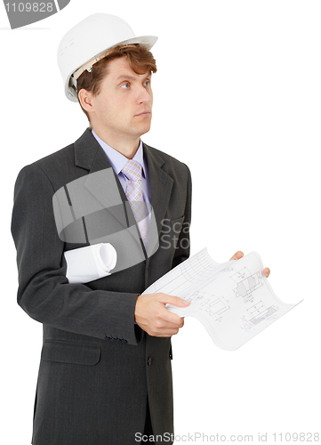 Image of Serious engineer in helmet with documentation in hands