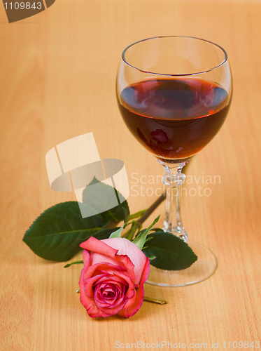 Image of Glass of red wine and rose