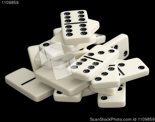 Image of Heap of dominoes isolated on black background