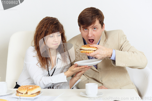 Image of A pair of businessmen lunching in workplace