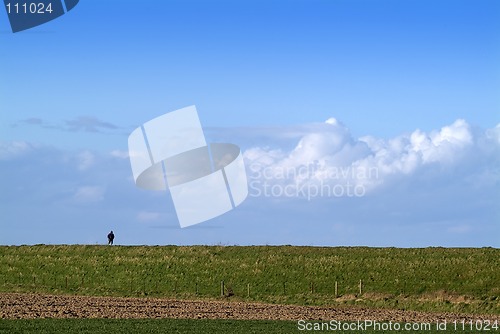 Image of Figure in huge landscape