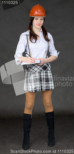 Image of Beautiful woman in helmet with tablet in hands