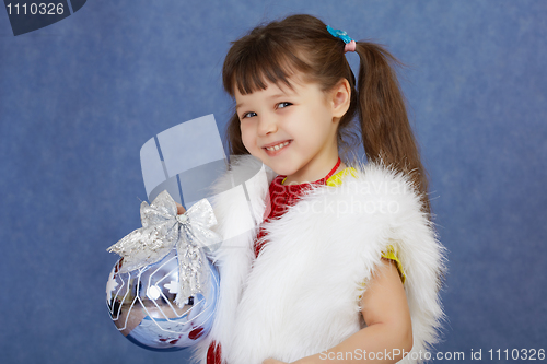Image of Little girl in white fur costume holding glass ball