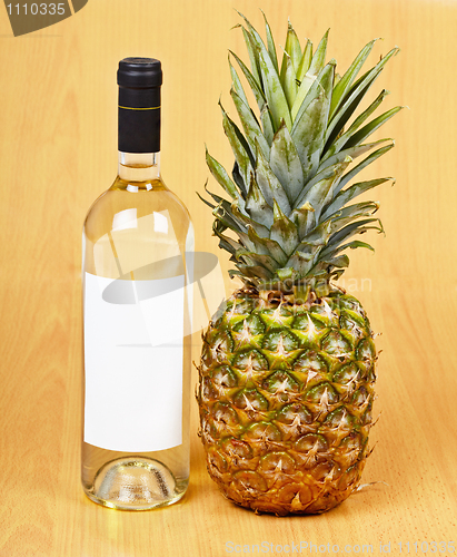 Image of Bottle of white wine and large pineapple