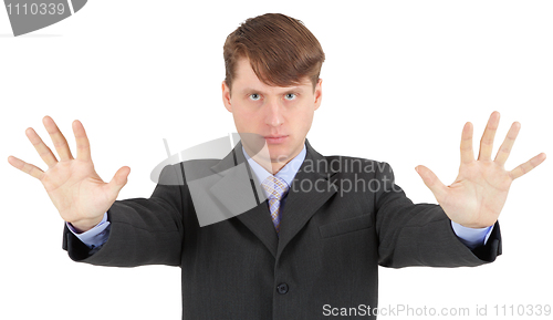 Image of Young businessman extended his arms to show us - stop!