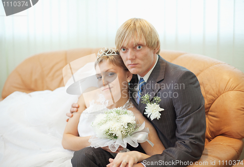 Image of Future husband and wife on leather sofa