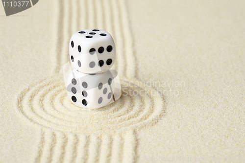 Image of Composition on Zen garden - sand, and two dice