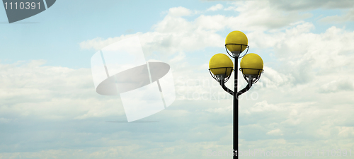 Image of Ancient lamppost against evening sky