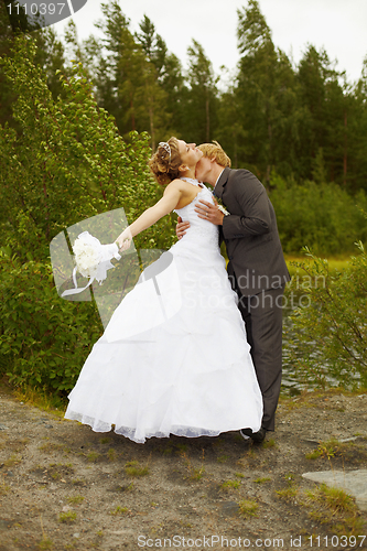 Image of Groom passionately kisses bride