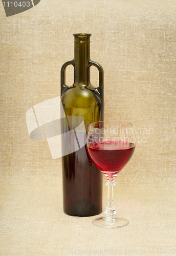 Image of Bottle and glass with red wine